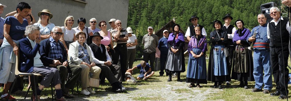 La fête de l'école de Brunissard : les femmes sont en gounelle, la robe traditionnelle du Queyras, et portent le châle, les hommes sont en pantalon et gilet noirs.